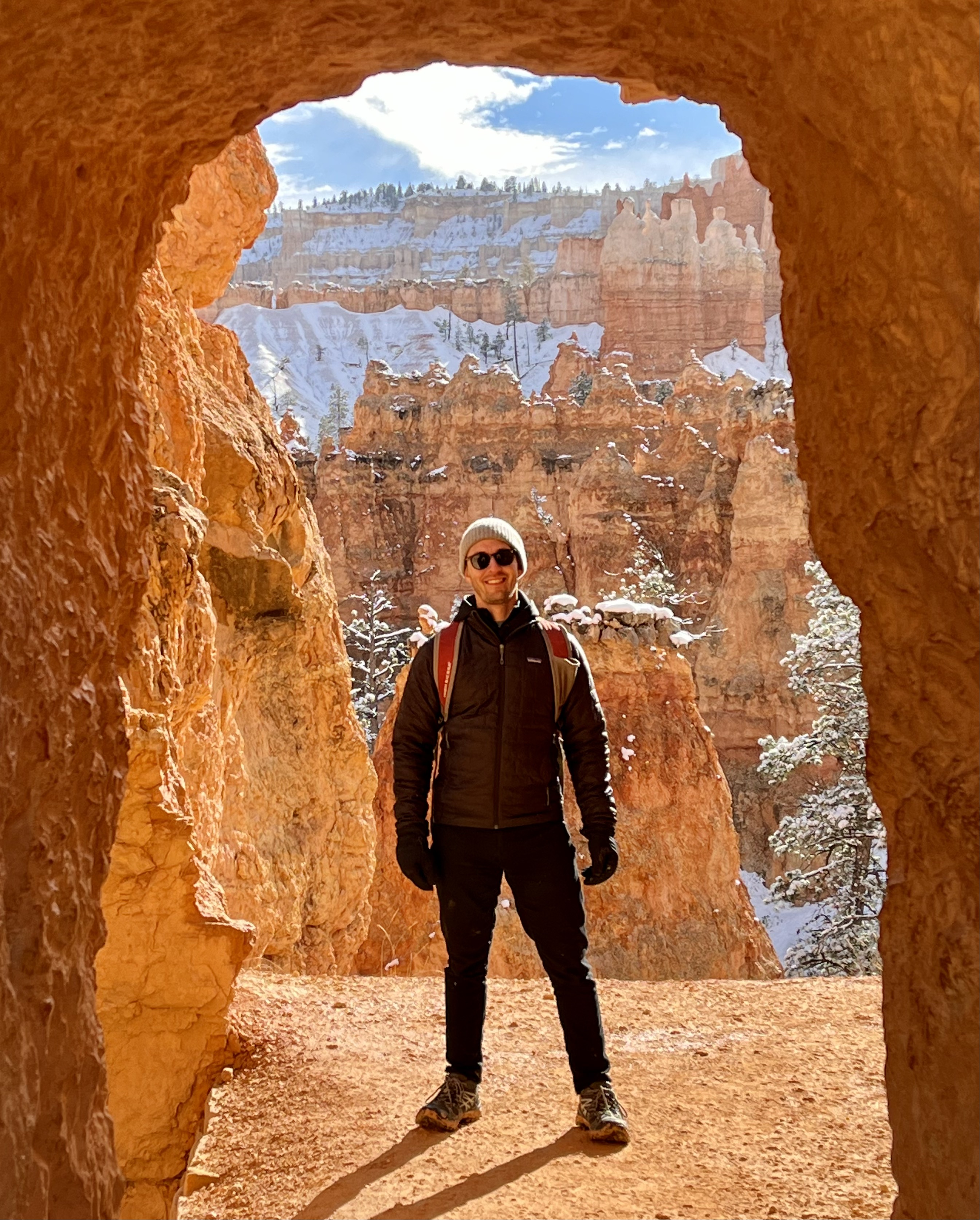 Josh Kraskin standing in a natural rock archway at Bryce Canyon